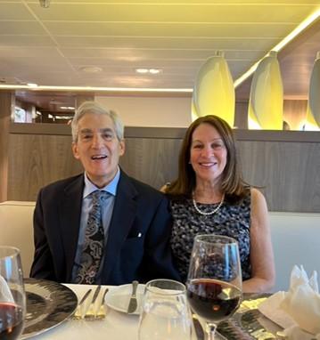 Susan and Sid smiling at dinner