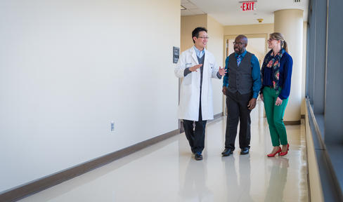 Doctor walking with patients.