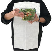 Person holding salad while wearing a NEAT Sheet assistive device to keep food spills from staining clothes.