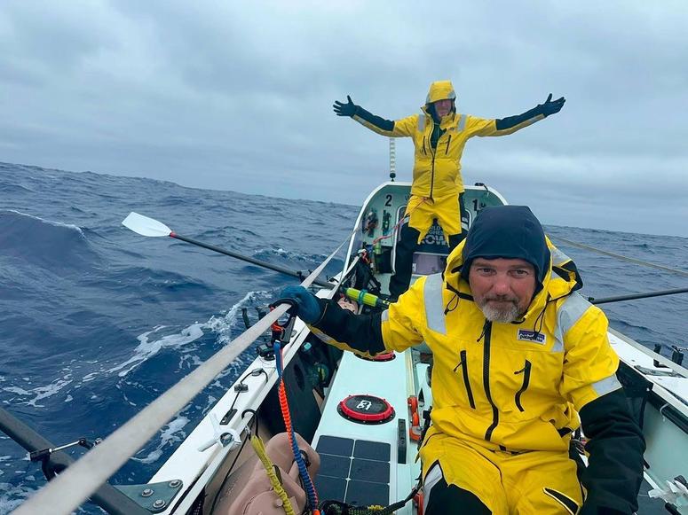 Patrick and Peter on their boat in weather gear