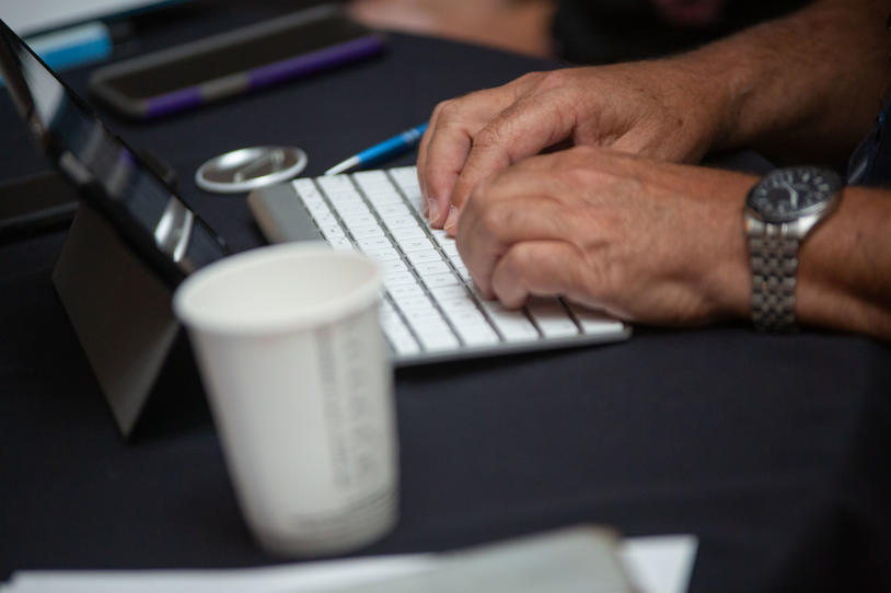 Hands typing on a keyboard