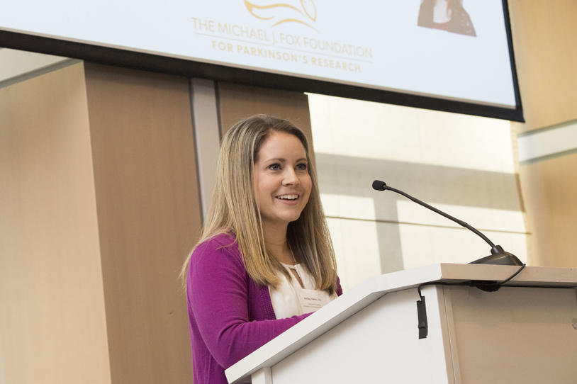 Ashley Harms, PhD, at a podium.