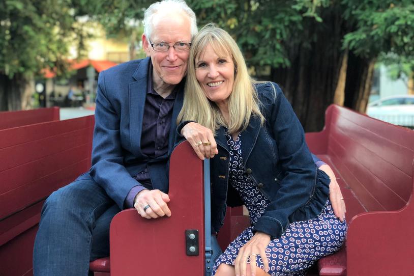 Man and woman smiling at camera.