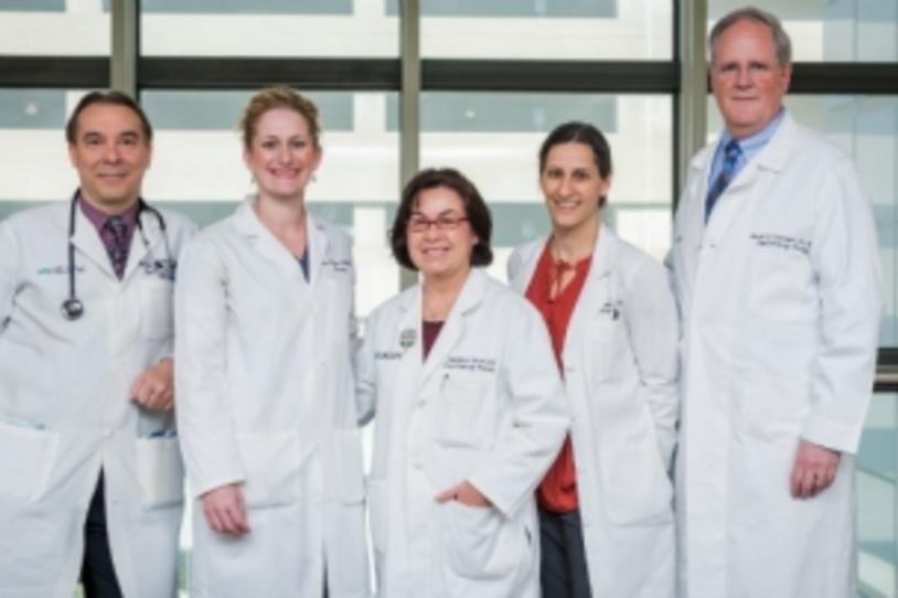 Doctors in white coats smiling.