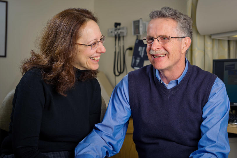 Female and male couple smiling in the doctor's office.