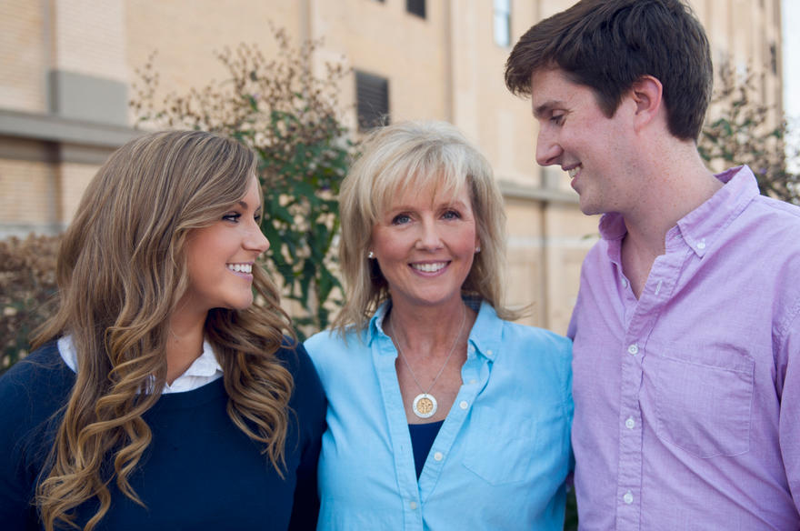 MJFF community member Nancy Mulhearn smiling at camera with her two children on either side.