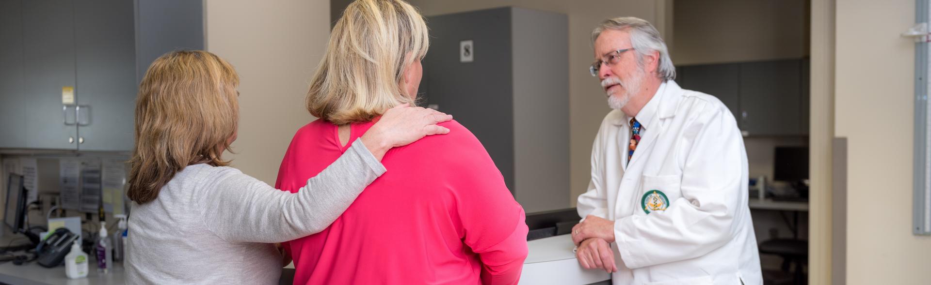 Doctor speaking to two people