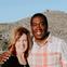 Man and woman smiling at camera.