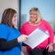 Female nurse and woman with Parkinson's in the doctor's office looking over a pamphlet.