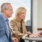 Man and woman sitting at a table with a laptop