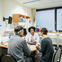 Three people talking at a clinic