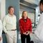 Researchers talking with couple in lab.