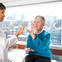 Female doctor performing a Parkinson's test with female patient.